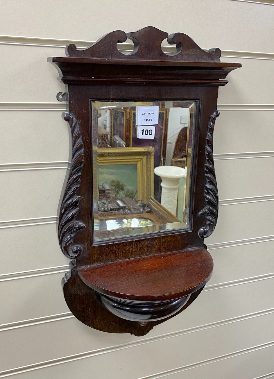 A late Victorian mahogany mirrored wall bracket, width 33cm, height 56cm